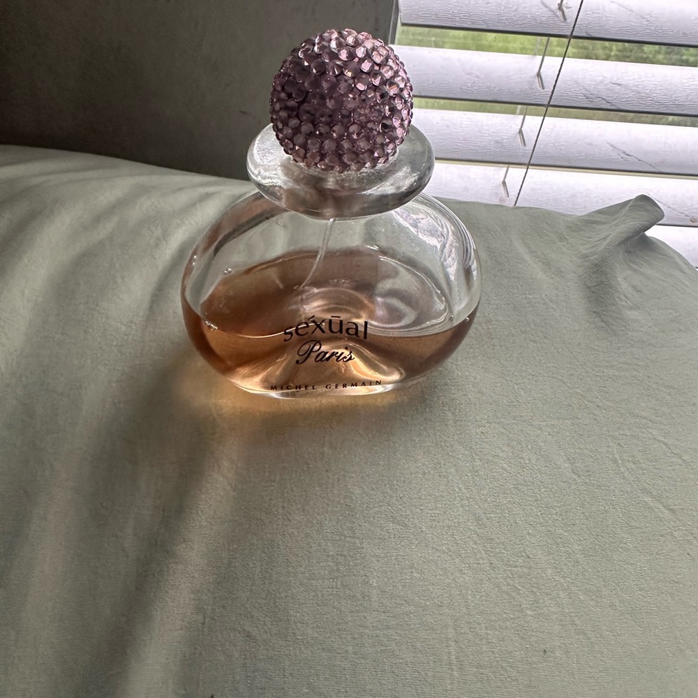 Pink Glass Decor Bottle with perfume Textured Stopper bottle is half way full